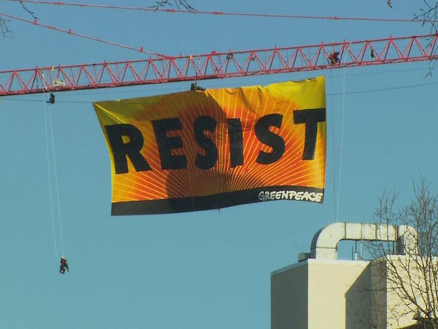Activists climb construction crane near the White House, unfurl 'resist' banner