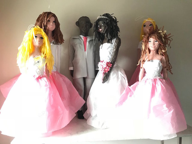 A Minnesota pinata maker says he is sorry for hanging black figures from his porch